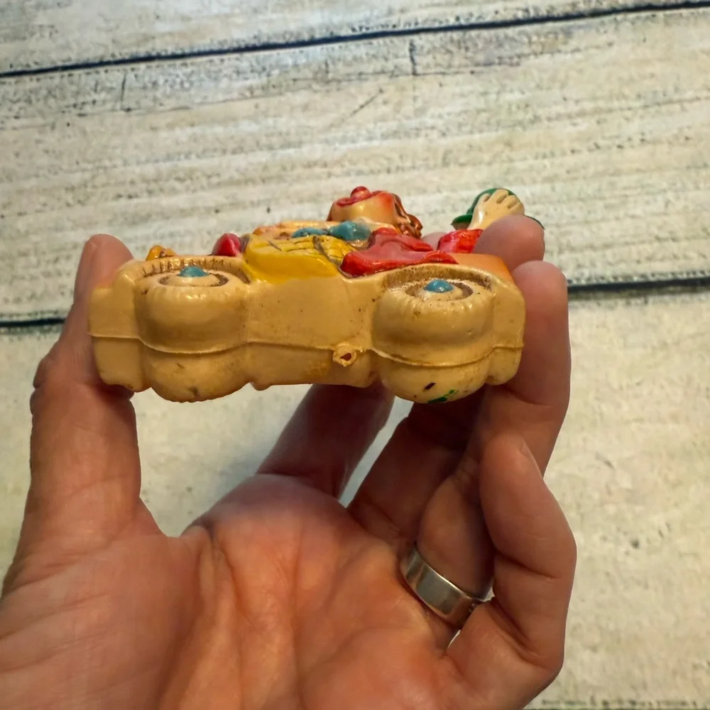 Vintage clown figurine riding in a car. Made in Japan.